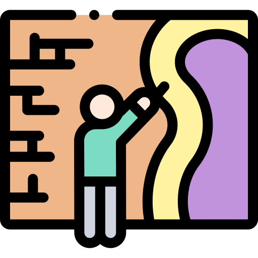 Un homme utilisant un outil pour dessiner sur une surface colorée, représentant la créativité et l'art.